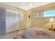 Bedroom featuring fan, bright window, closet, lamp, and small side table at 1250 N Portofino Dr # 208, Sarasota, FL 34242