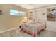 Bedroom featuring a fan, a bright window, and built in white cabinets with drawers and shelves at 1250 N Portofino Dr # 208, Sarasota, FL 34242