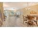 Charming dining area with wood floors, elegant chandelier, and sliding glass doors offering ample natural light at 1250 N Portofino Dr # 208, Sarasota, FL 34242