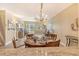 Dining room with hardwood floors and elegant chandelier illuminated by natural light at 1250 N Portofino Dr # 208, Sarasota, FL 34242