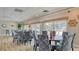 Community dining area with tables, chairs, and large windows offering bright views of the outdoors at 1250 N Portofino Dr # 208, Sarasota, FL 34242
