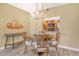 Warm dining area with chandelier and seating for four, open to kitchen at 1250 N Portofino Dr # 208, Sarasota, FL 34242