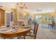 Inviting dining room showcasing a round table setting, decorative artwork, and a bright, airy atmosphere with natural light at 1250 N Portofino Dr # 208, Sarasota, FL 34242