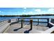 Community waterfront dock with seating for relaxing and enjoying picturesque water views at 1250 N Portofino Dr # 208, Sarasota, FL 34242