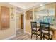 Cozy kitchen with breakfast bar and view to dining area featuring tile floors and natural light at 1250 N Portofino Dr # 208, Sarasota, FL 34242