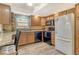 Kitchen features stainless steel appliances, stone counters, and wood cabinets at 1250 N Portofino Dr # 208, Sarasota, FL 34242