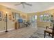 Cozy living room featuring stylish furnishings, wood-look tile flooring, and sliding glass doors leading to a balcony at 1250 N Portofino Dr # 208, Sarasota, FL 34242