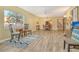 Comfortable living room featuring tiled floors, ceiling fan, and view to dining area at 1250 N Portofino Dr # 208, Sarasota, FL 34242