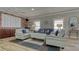Inviting living room with comfortable seating, brick accent wall, and bright, natural light from shuttered windows at 1250 N Portofino Dr # 208, Sarasota, FL 34242