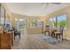 Bright living room with wood-look floors, comfortable seating, and large windows offering picturesque views of the outdoors at 1250 N Portofino Dr # 208, Sarasota, FL 34242