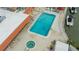 Overhead view of sparkling pool and spa with lounge chairs, boats, and well-maintained patio area at 1250 N Portofino Dr # 208, Sarasota, FL 34242