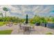 A beautiful amenity area features outdoor seating, a firepit, and peaceful water views, perfect for relaxation and entertainment at 137 Woodland Pl, Osprey, FL 34229