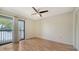 Bedroom with wood floors, balcony, and closet at 137 Woodland Pl, Osprey, FL 34229