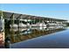 Covered boat slips on the water with multiple boats docked, reflecting in the water at 137 Woodland Pl, Osprey, FL 34229