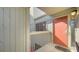 View of front door with a welcoming mat, showing exterior wall and small window for natural lighting at 137 Woodland Pl, Osprey, FL 34229