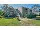 Inviting two-story condo with well-maintained landscaping, walkway, and staircase to the upper units at 137 Woodland Pl, Osprey, FL 34229