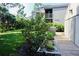 Exterior view with garden showcasing the building's well-maintained landscaping and design at 137 Woodland Pl, Osprey, FL 34229