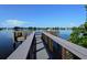 A lovely pier with a shaded fishing spot on a sunny day with boats in the distance at 137 Woodland Pl, Osprey, FL 34229