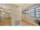 Bright foyer with wood-look floors that flow into the kitchen, with large windows for ample natural light at 137 Woodland Pl, Osprey, FL 34229