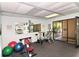Well-equipped gym featuring exercise machines, weights, and a mirror, ideal for a complete workout routine at 137 Woodland Pl, Osprey, FL 34229