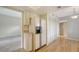 Open kitchen with stainless steel refrigerator, ample cabinet space, and wood-look flooring throughout at 137 Woodland Pl, Osprey, FL 34229