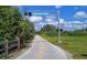 Scenic view of The Legacy Trail, perfect for biking and walking, under a bright blue sky with fluffy clouds at 137 Woodland Pl, Osprey, FL 34229