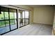 Inviting living room boasts new carpet and sliding glass doors opening to a private balcony with seating at 137 Woodland Pl, Osprey, FL 34229