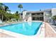 Large community pool with lounge chairs and well-maintained landscaping provides a luxurious outdoor experience at 137 Woodland Pl, Osprey, FL 34229