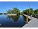 Picturesque view of a walkway over the water with lush greenery and blue skies at 137 Woodland Pl, Osprey, FL 34229