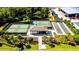 Aerial view of tennis courts and bocce ball court surrounded by mature trees at 16804 Vardon Ter # 307, Bradenton, FL 34211