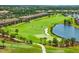 Aerial view of the golf course, adjacent to a lake and low-rise condos at 16804 Vardon Ter # 307, Bradenton, FL 34211