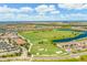 Aerial view of the community, showcasing the golf course and water features at 16804 Vardon Ter # 307, Bradenton, FL 34211