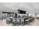 Full bar with bar stool seating and multiple flatscreen televisions at 16804 Vardon Ter # 307, Bradenton, FL 34211