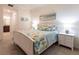 Comfortable bedroom featuring a white bed frame, two nightstands, and bathroom view at 16804 Vardon Ter # 307, Bradenton, FL 34211