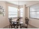 Bright breakfast nook with a glass table set and windows offering a lovely outdoor view at 16804 Vardon Ter # 307, Bradenton, FL 34211