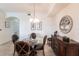 Warm dining room featuring a glass table, seating for four, and a wood sideboard at 16804 Vardon Ter # 307, Bradenton, FL 34211
