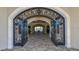 Grand entryway with wrought iron gate and stone archway, creating a welcoming and elegant arrival experience at 16804 Vardon Ter # 307, Bradenton, FL 34211