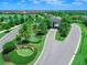 Entry to the community with stone detailing, mature trees, and lush landscaping at 16804 Vardon Ter # 307, Bradenton, FL 34211
