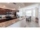 Bright kitchen featuring granite countertops, stainless steel appliances, and adjacent breakfast nook at 16804 Vardon Ter # 307, Bradenton, FL 34211