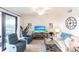 Cozy living room featuring comfortable furniture and sliding glass doors at 16804 Vardon Ter # 307, Bradenton, FL 34211