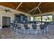 A spacious outdoor bar features a large counter, ample seating, and multiple television screens at 16804 Vardon Ter # 307, Bradenton, FL 34211