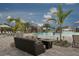Outdoor community pool with lounge seating, tropical plants, and a waterfall feature at 16804 Vardon Ter # 307, Bradenton, FL 34211