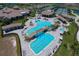 Aerial view of a resort style pool with waterfall features and sundeck with lounge chairs at 16804 Vardon Ter # 307, Bradenton, FL 34211