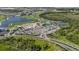 Beautiful aerial view of the community featuring tennis courts, parking, and lush green landscaping at 17632 Santorini Ct, Venice, FL 34293