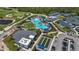 Resort-style community aerial featuring a pool, tennis courts, clubhouse, and landscaped grounds at 17632 Santorini Ct, Venice, FL 34293