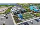 Overhead view of the community clubhouse with bocce ball court, pool, and parking at 17632 Santorini Ct, Venice, FL 34293