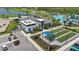 An aerial view shows a community center, pool, bocce ball courts, and lush landscaping at 17632 Santorini Ct, Venice, FL 34293