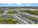 A Primary-planned community with homes, a golf course, and water features are all visible in this aerial view at 17632 Santorini Ct, Venice, FL 34293