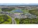 Aerial view of the community and surrounding area highlighting the golf course, lake, and clubhouse at 17632 Santorini Ct, Venice, FL 34293