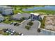 Exterior aerial view of the community clubhouse with well-manicured landscaping and parking at 17632 Santorini Ct, Venice, FL 34293